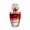 Frasco de vidro arredondado com textura hexagonal, cor degradê cobre escuro. Tampa de vidro redonda com detalhes de confetes na cor bronze rosado. Rótulo no topo e na base com o nome do produto e marca em letras douradas sobre o fundo rosado do líquido.